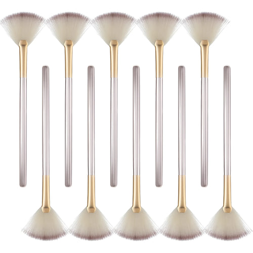 Ten champagne-coloured facial fan brushes with soft bristles and protective covers laid out.