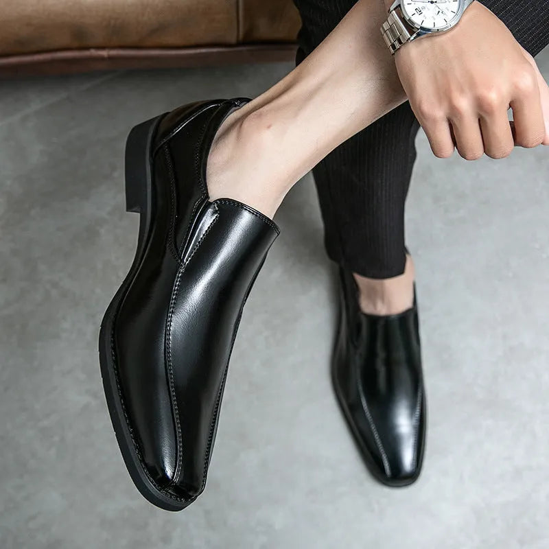 Men's black patent leather pointed toe casual shoes with a flat heel and totem design on a white background.