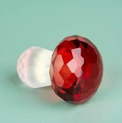 Colourful geometric crystal mushroom decoration on a white background.
