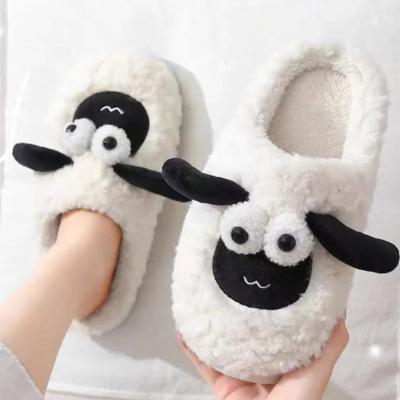 A pair of lamb thermal cotton slip-on slippers with a suede upper and sewn PVC sole.