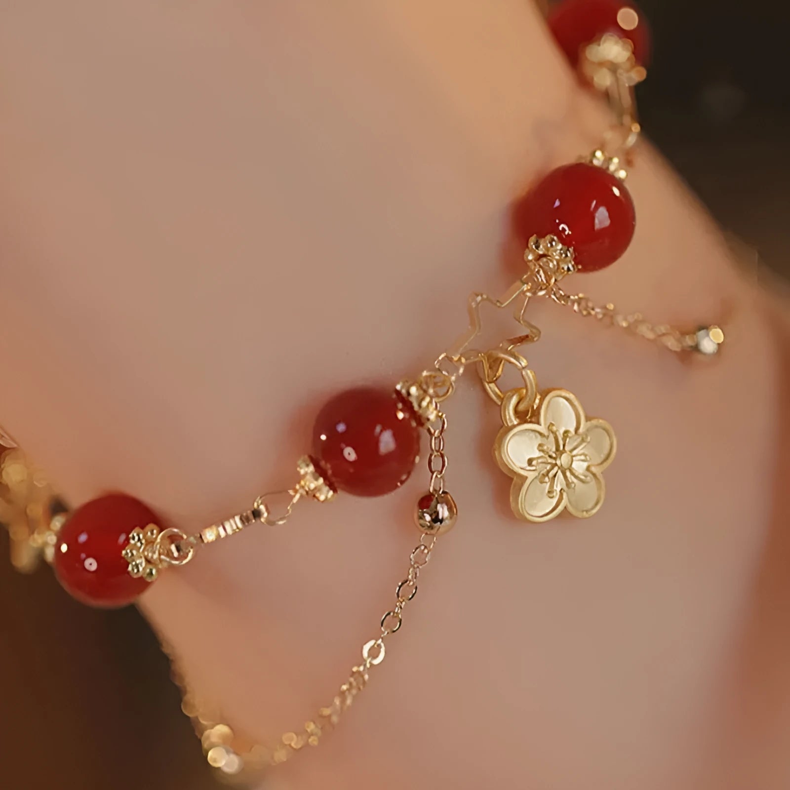 Red agate double layer women's bracelet with carved peach blossom and floral motifs.