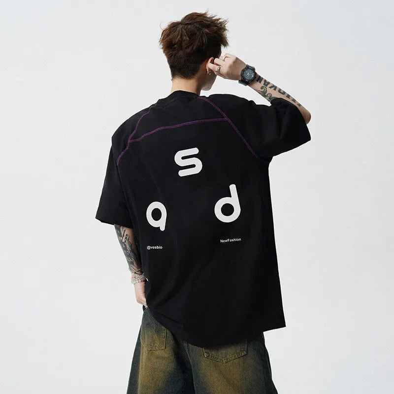 Loose-fit black cotton short-sleeve t-shirt with white letter print graphic on a mannequin.