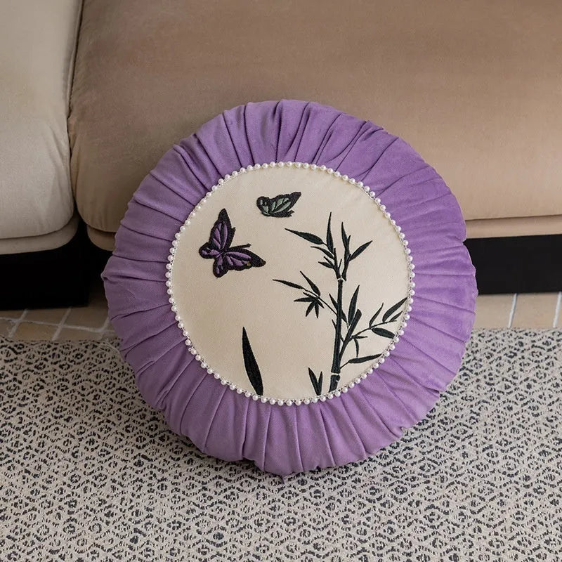 Square beige cushion with black butterfly embroidery in a Chinese style, 45cm by 45cm.