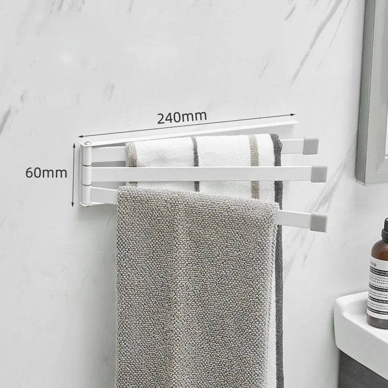 Black folding towel rack mounted on a bathroom wall with towels hanging, showing its no-drill installation.