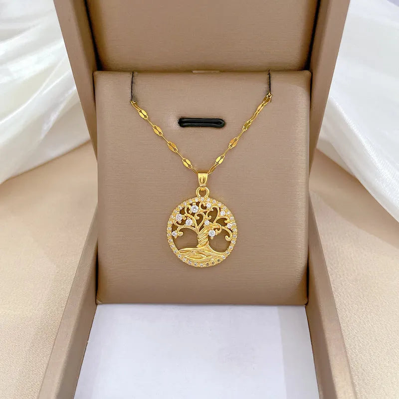 Gold plated necklace with tree and cross pendant featuring mother of pearl and rhinestones on adjustable chain