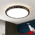 Round modern LED ceiling light with an iron frame in black or white, shown in a room setting.