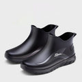 Men's short PVC rubber boots in beige, black, and black & red colours on a flat heel