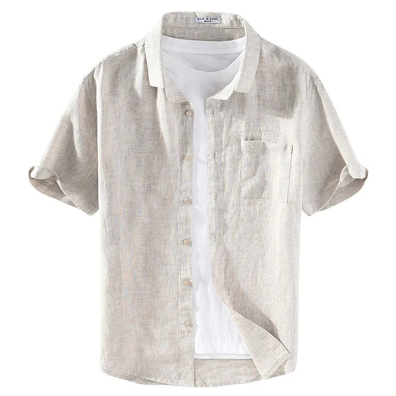 Man wearing a raw jute coloured short sleeve linen shirt with a square collar, showing the casual cardigan style.