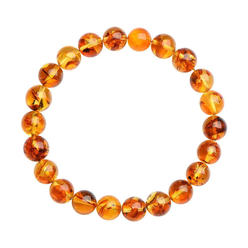 Natural yellow piebald amber bracelet with polished geometric beads on a wrist.
