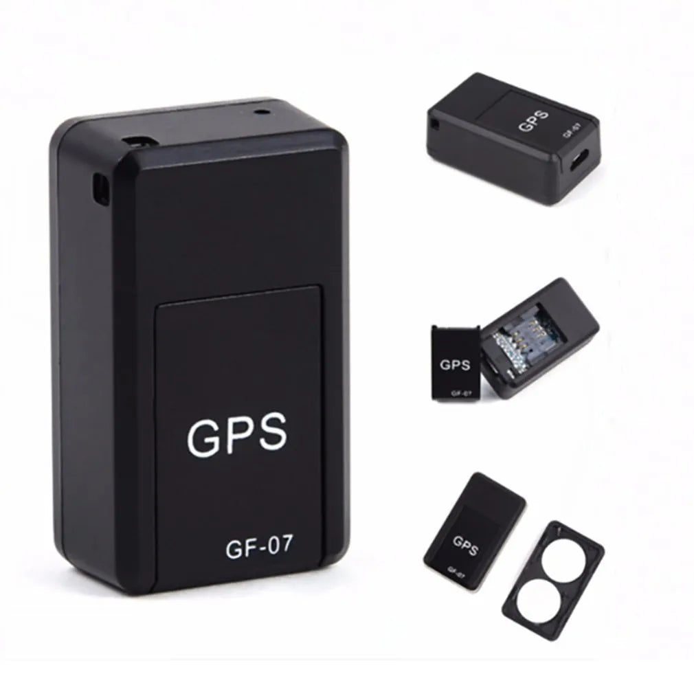 Small black plastic magnetic GPS tracker device with USB charging cable.