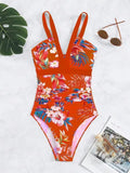 Women's black floral pattern backless one-piece swimsuit laid flat.