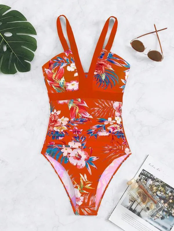 Women's black floral pattern backless one-piece swimsuit laid flat.