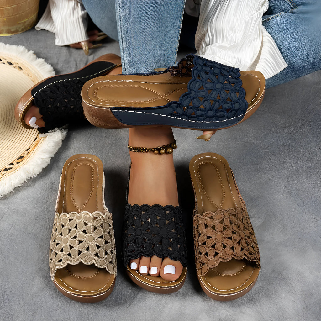 Women's wedge beach slippers with flower cutout design in PVC material showing fish mouth toe shape