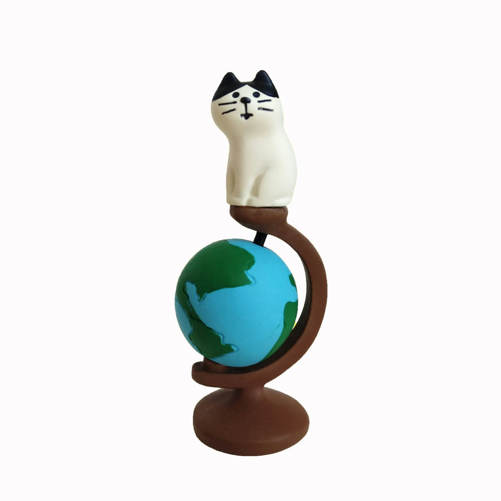 Cartoon cat dressed as Statue of Liberty resin craft figurine on desk.