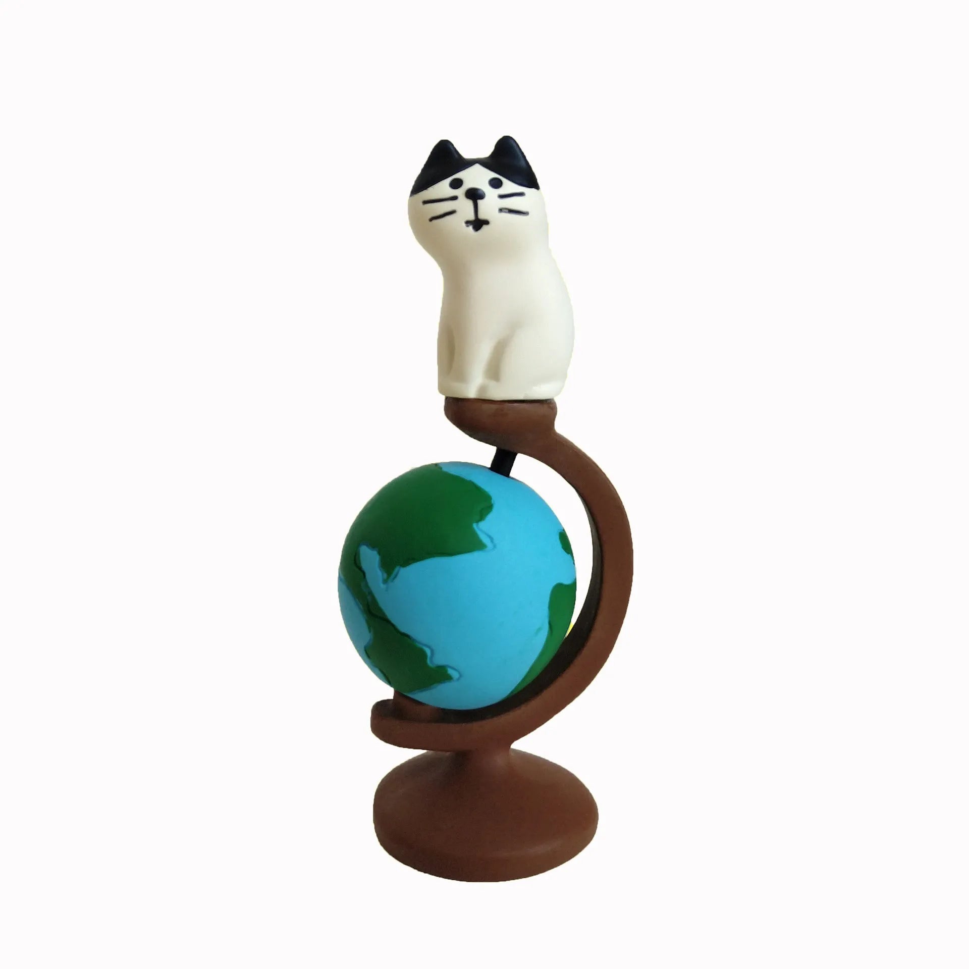 Cartoon cat dressed as Statue of Liberty resin craft figurine on desk.