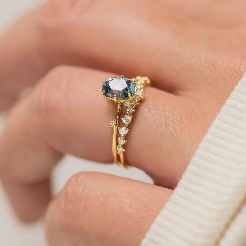 Gold electroplated women's ring with floral design and green zircon stone inlays on alloy base