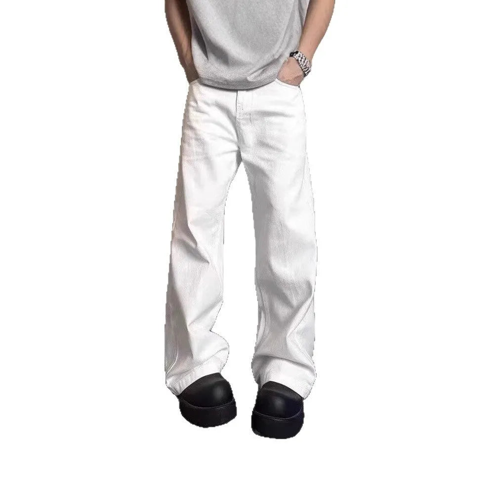 Men's white straight-leg denim jeans with a wide leg opening and a zip fly.