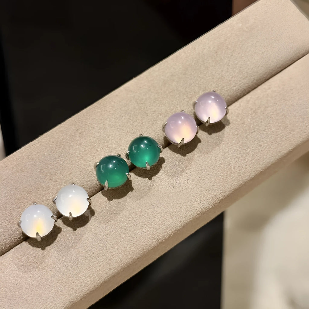 Chinese style chalcedony stud earrings with four-claw stone settings and round geometric design