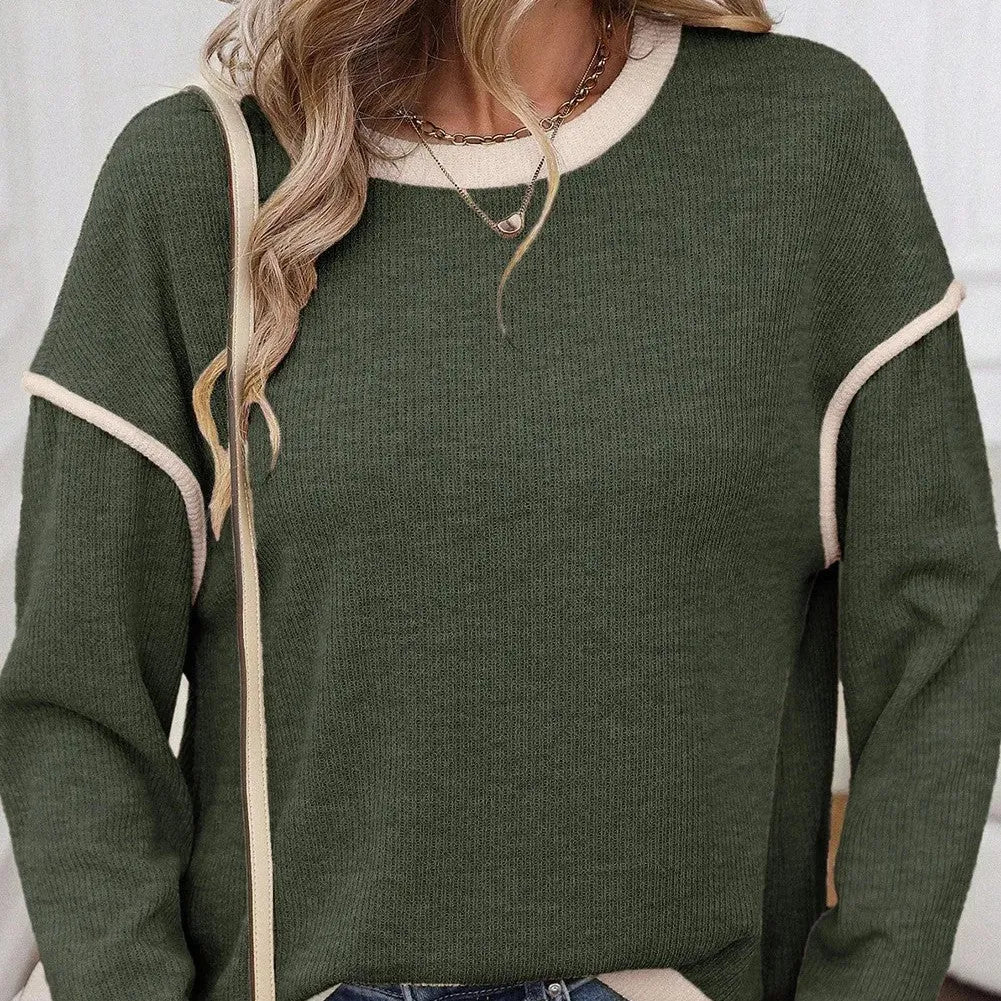 Woman wearing a loose drop shoulder knit top with contrast trim, shown in beige, light pink, and four leaf clover print colours.