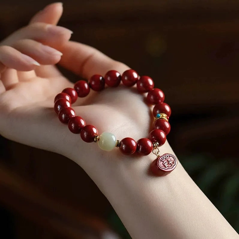 Natural red cinnabar bracelet with Ping An Fu Lu symbol carved in emperor sandstone style.