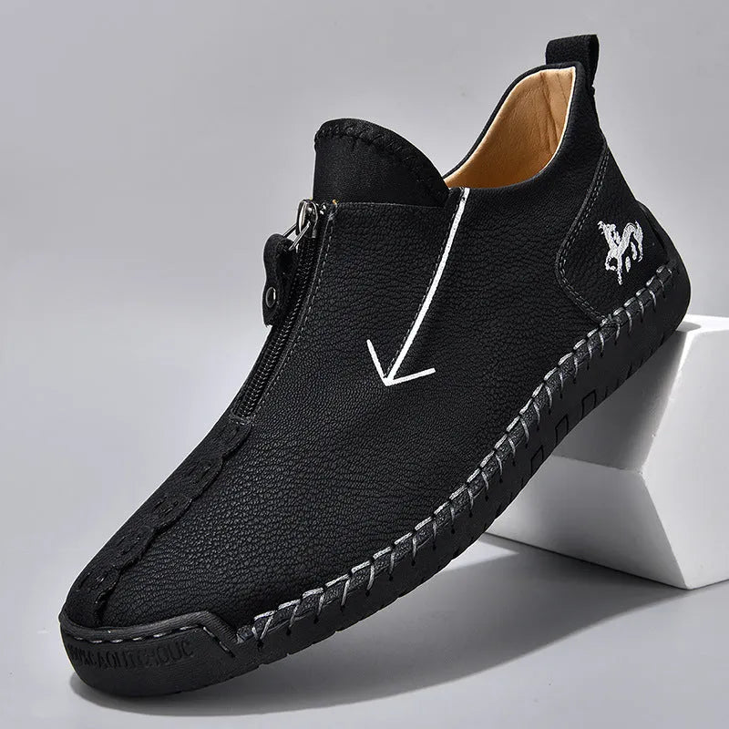 Men's black zip-up casual leather boots with round toe and hand-stitched rubber sole.