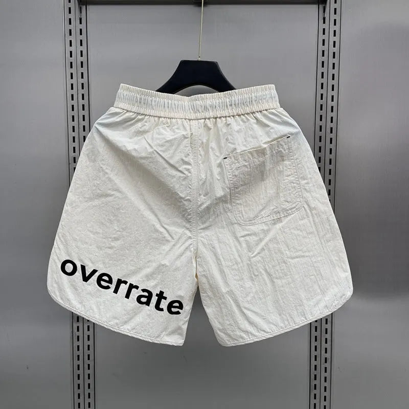 Men's lightweight polyester casual summer shorts in black or apricot with medium elastic waist, sizes M to 3XL