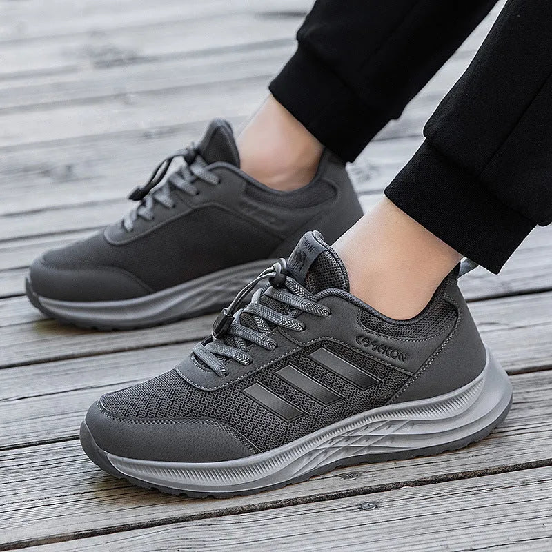 Men's and women's black mesh slip-on casual shoes with an elastic band across the instep.
