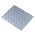 Modern aluminium quick defrosting plate for food with included USB cable on a kitchen counter