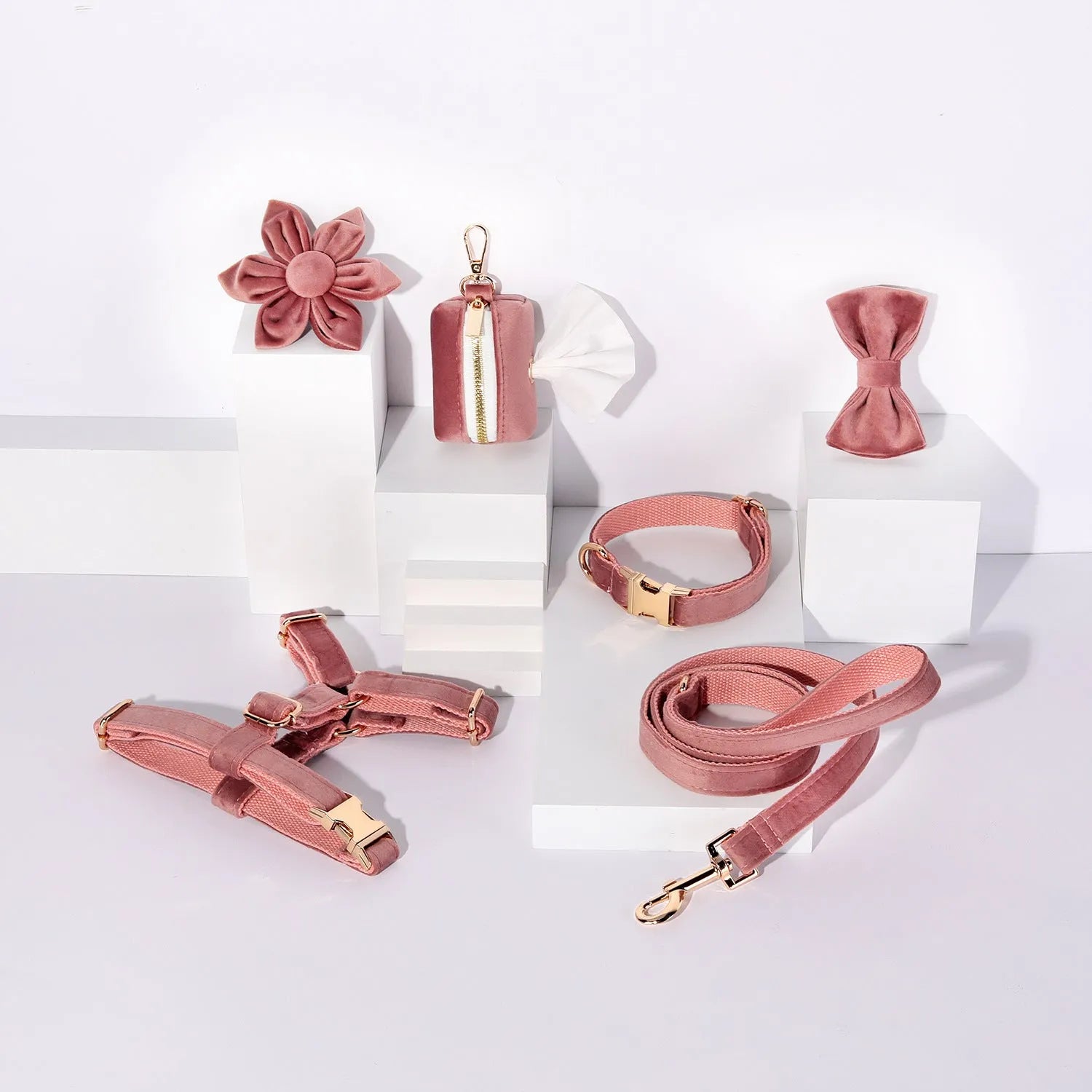 Complete velvet dog collar and traction rope set with bow tie, flower, and toilet bag on a table