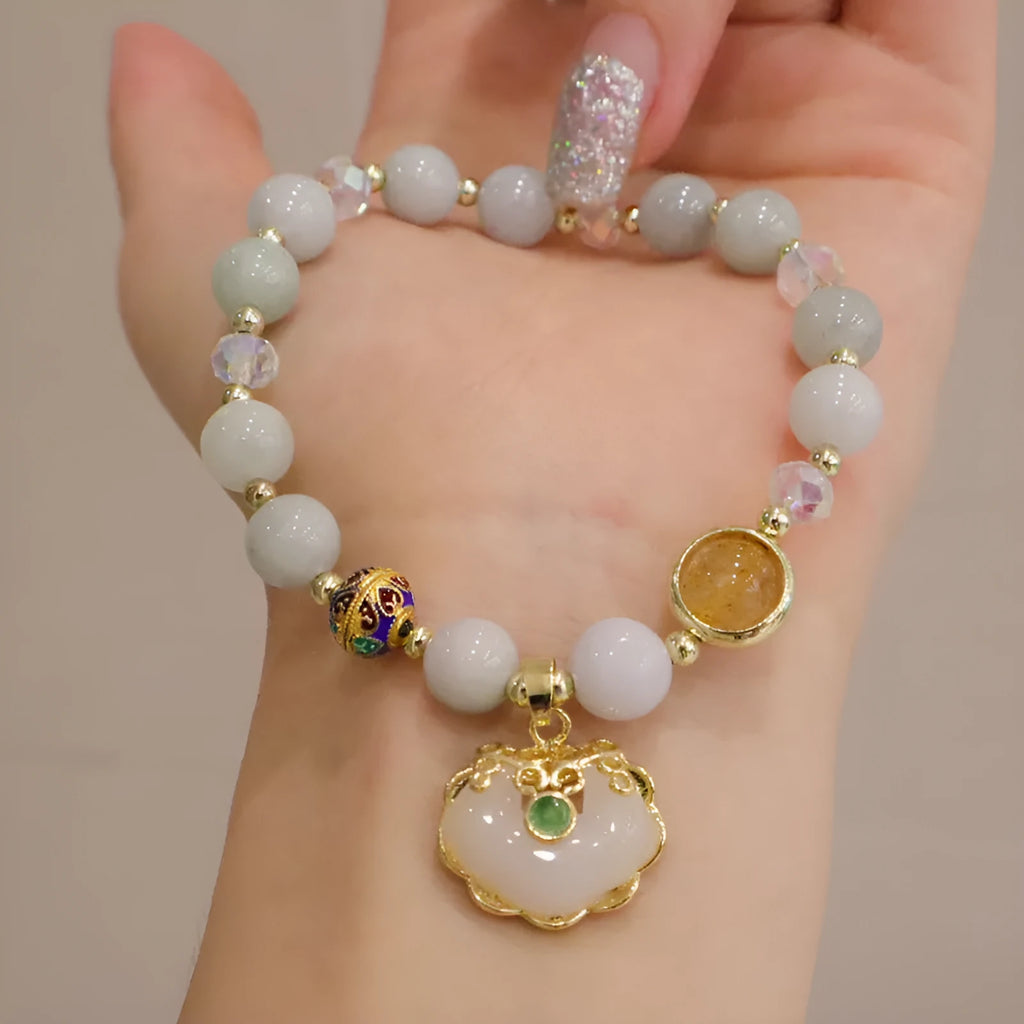 Women's ethnic bracelet with geometric metal decorations and strawberry quartz or gray jade beads