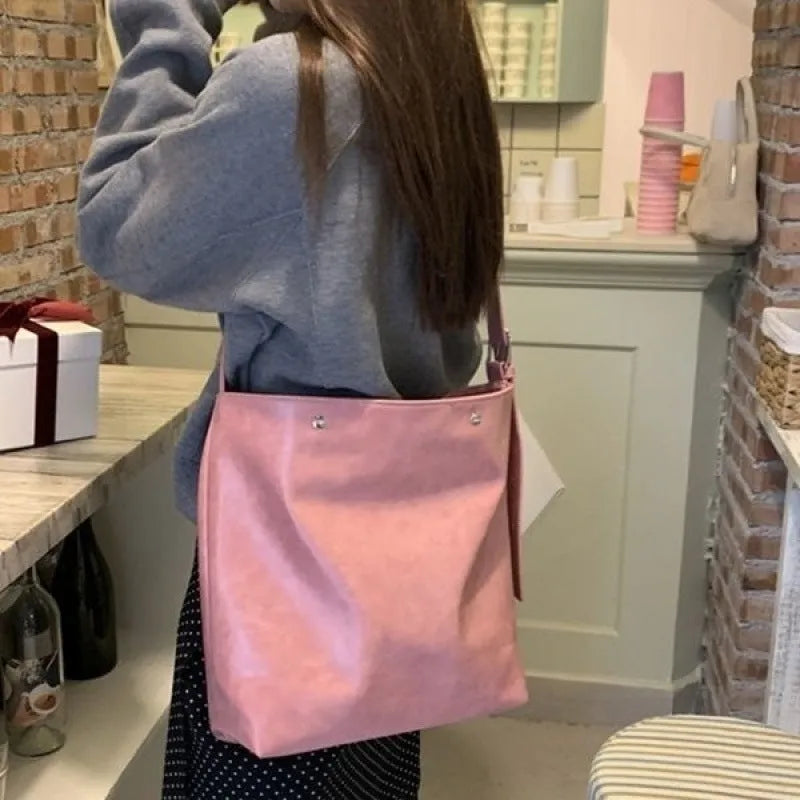 Corduroy commuter shoulder bag in pink colour with one-shoulder carry design