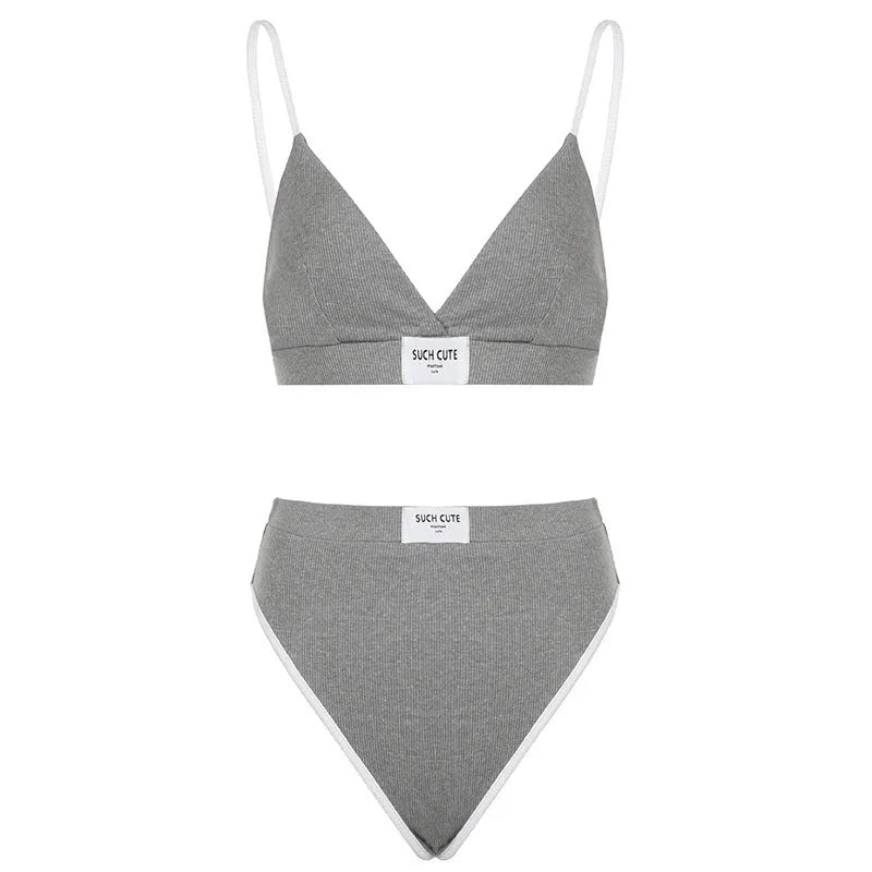 Women's black bikini set with white contrast binding and embroidery detail on the top and shorts.