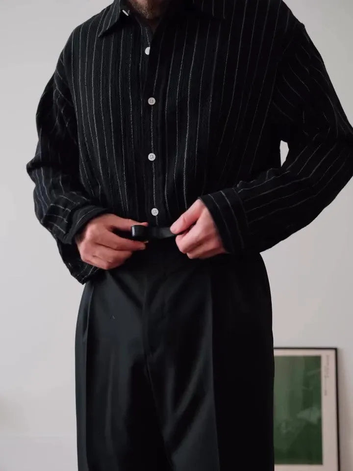 Black pinstripe button-down shirt on hanger showing striped pattern and button front
