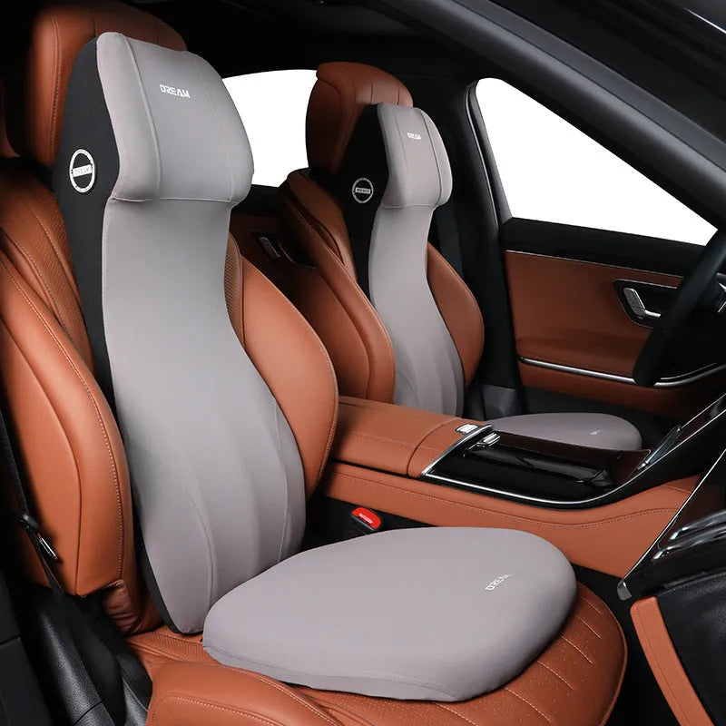 Black automotive memory foam seat cushion with integrated lumbar support headrest pillow.