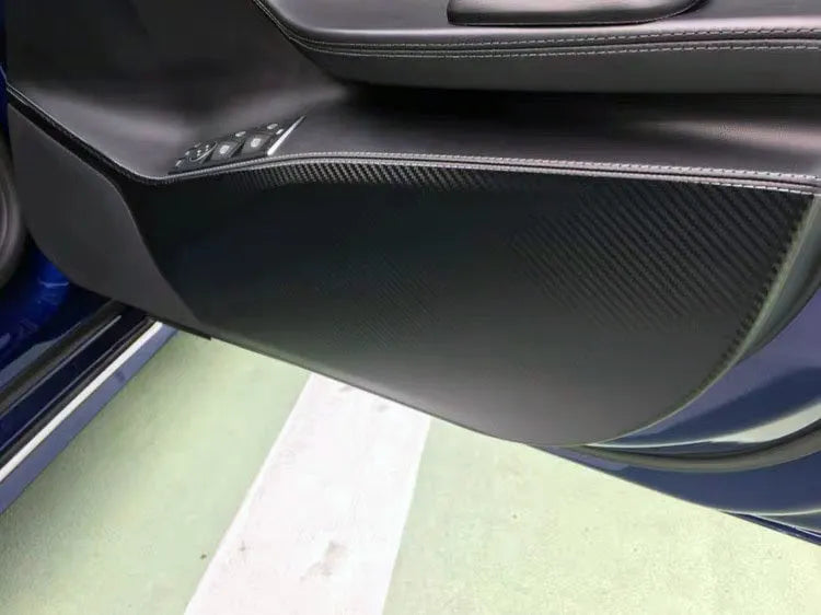 Four-piece carbon fibre pattern protective film kit for Tesla Model S car door interior panels.