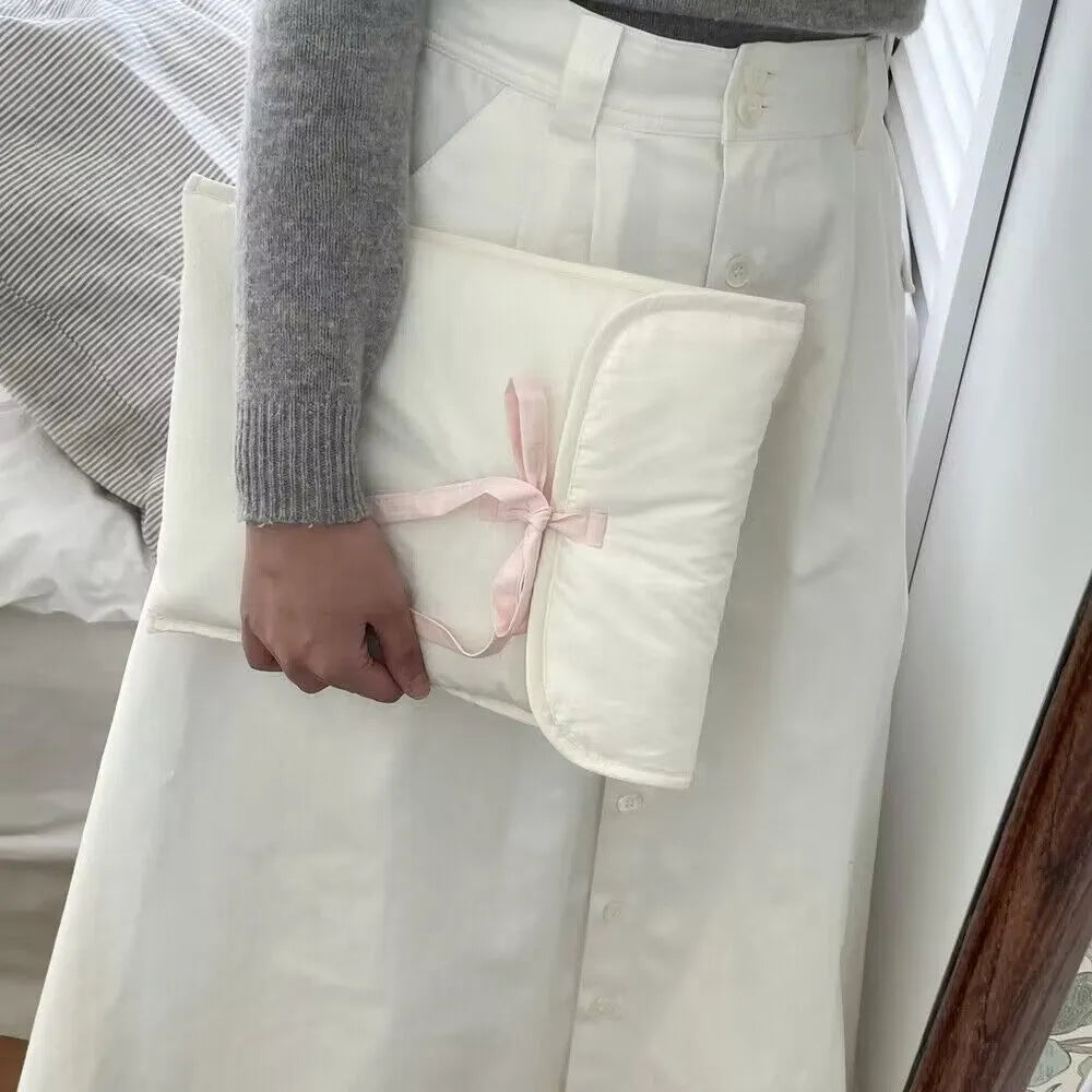 Women's black quilted computer bag with ballet bow and striped lining