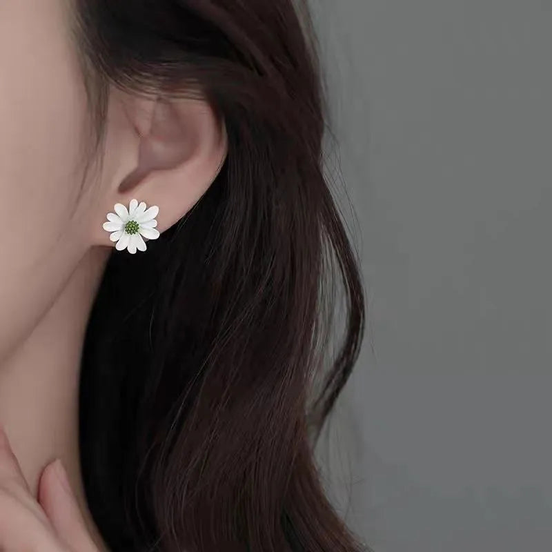 Close-up of cartoon-style flower stud earrings in alloy, shown in blue and orange two-tone colour combination.