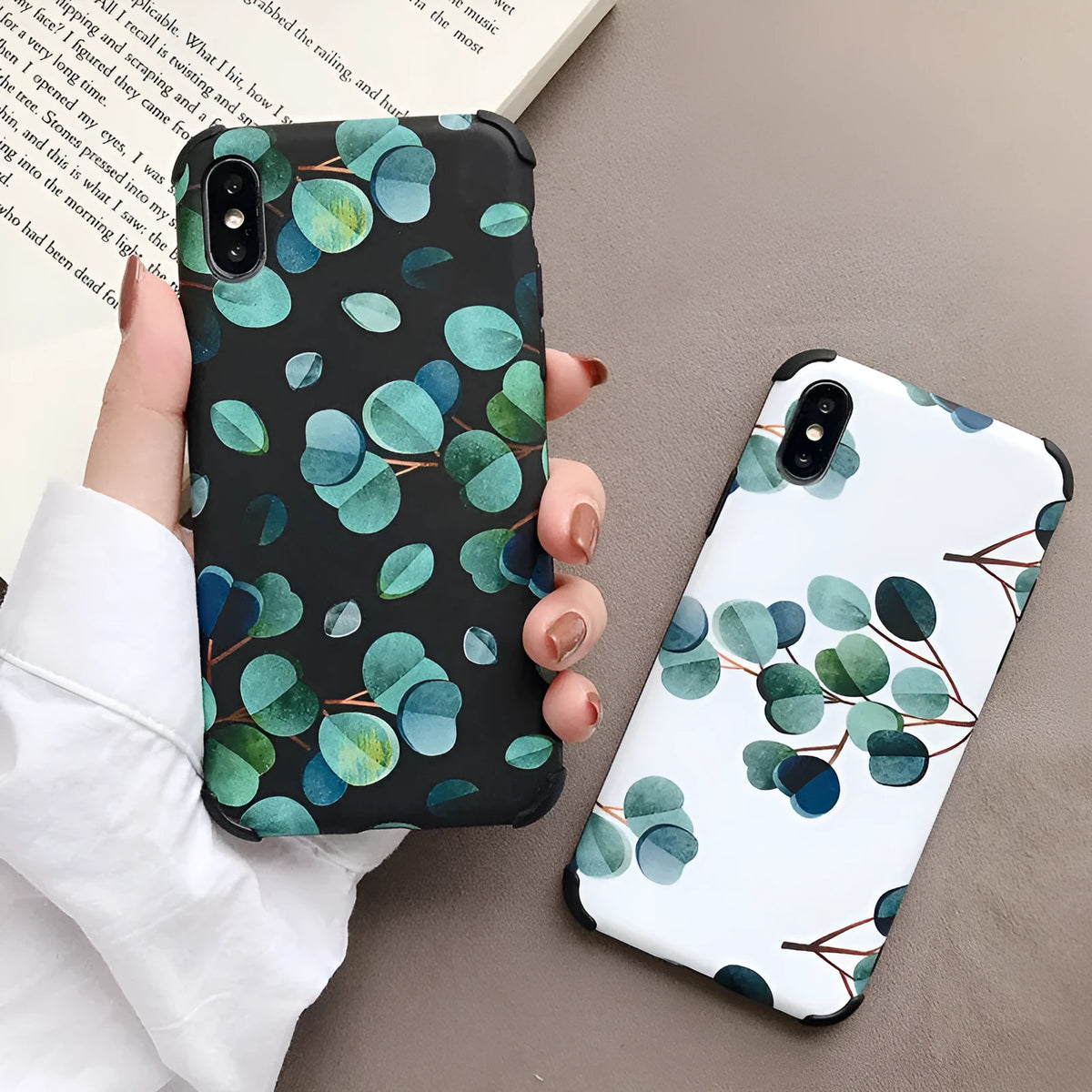 Black silicone iPhone case with a detailed raised leaf pattern design on the back.
