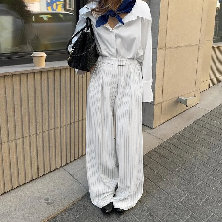 White striped wide-leg casual trousers with a zip closure on a hanger