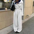 White striped wide-leg casual trousers with a zip closure on a hanger