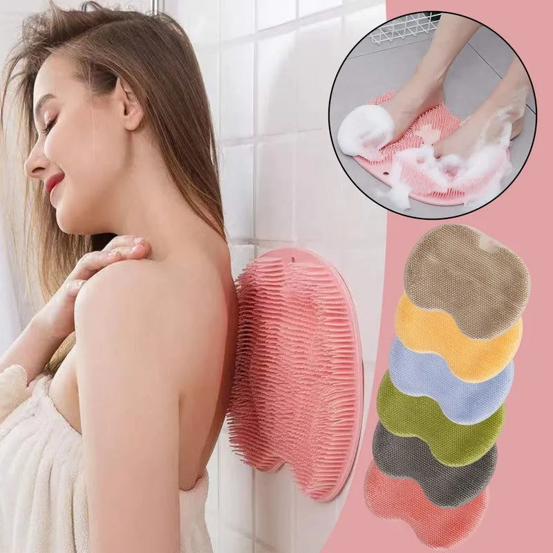 Orange silicone bath brush with suction cups on back and hundreds of small bristles for cleaning feet and back.