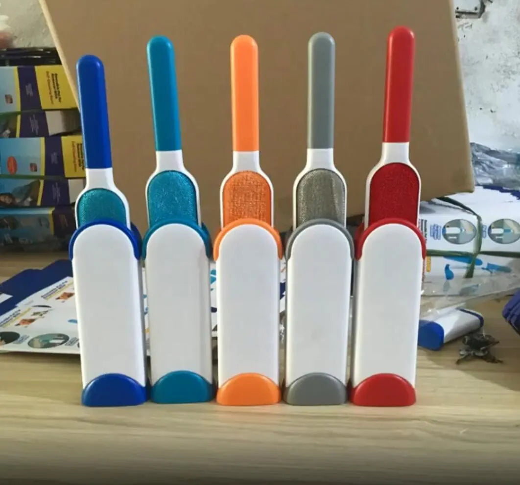Blue reusable pet hair remover brush with self-cleaning base for removing fur from a grey sofa.