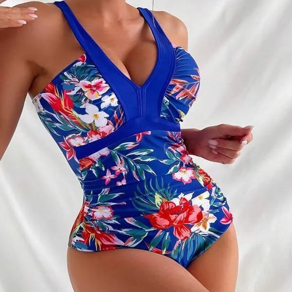 Women's black floral pattern backless one-piece swimsuit laid flat.
