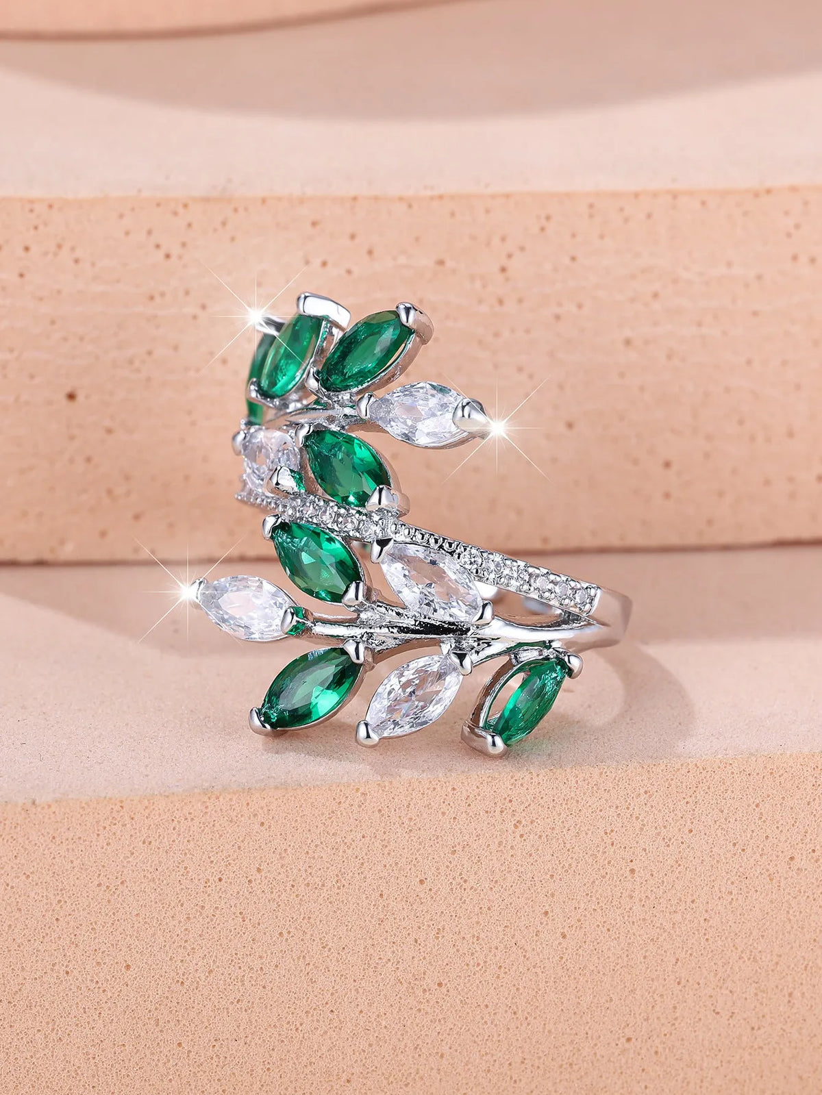 Adjustable copper leaf ring with zircon detailing in multiple colour options on display