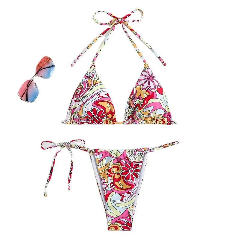 Women's multicolour triangle printed bikini with halter neck top and separate bottoms.