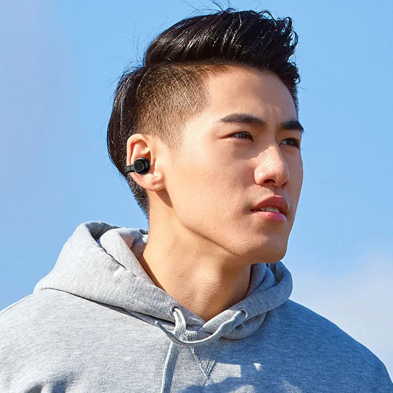 Black wireless bone conduction clip-on earphones with charging cable