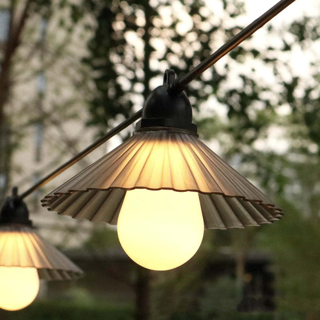 Outdoor LED string lights with flower-shaped globes shown in warm white and multi-colour settings.