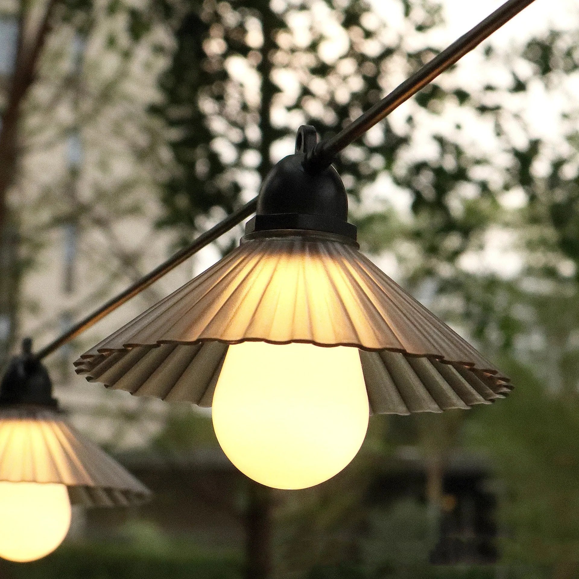 Outdoor LED string lights with flower-shaped globes shown in warm white and multi-colour settings.