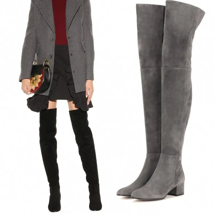 Grey suede women's over-the-knee flat boots with a pointed toe and low thick heel.