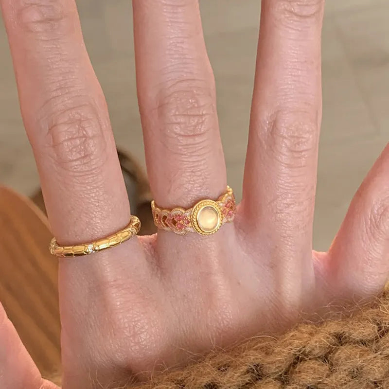Open geometric ring with pink crystal enamel decoration and gold-plated finish, adjustable design